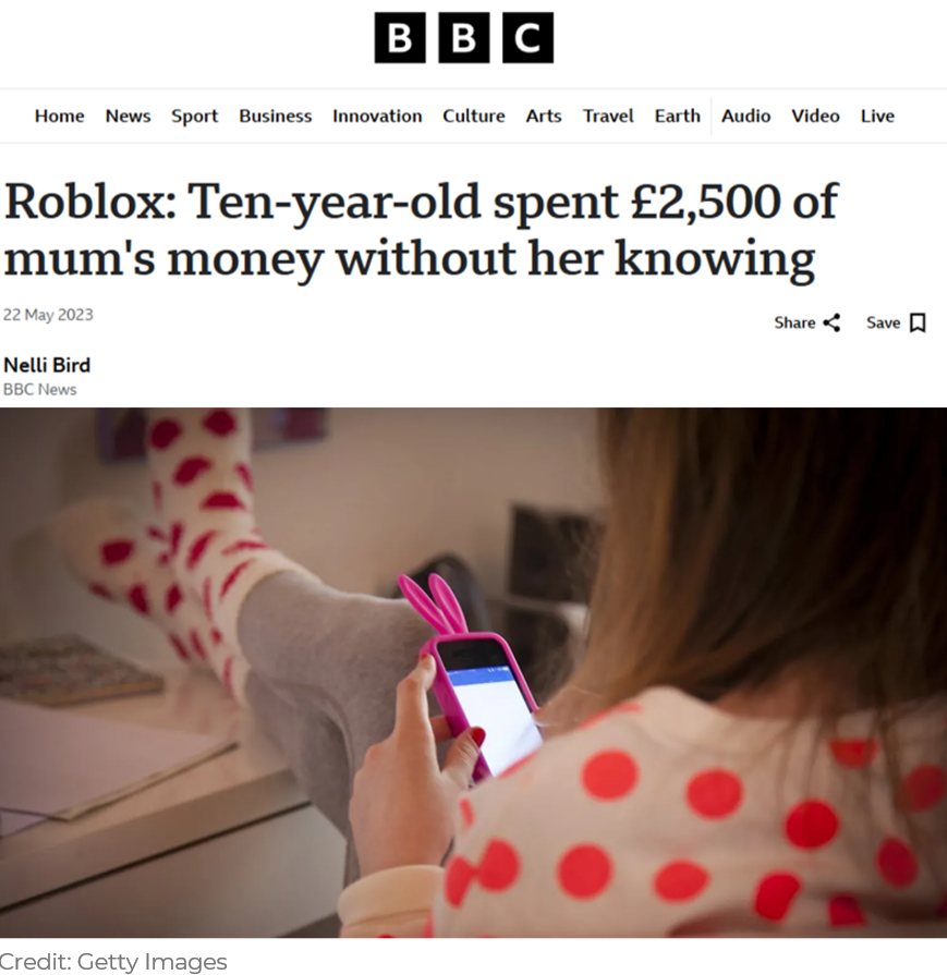 Child holding a phone showing the Roblox logo